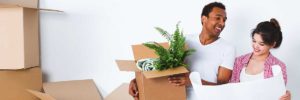 Couple with moving boxes and fern