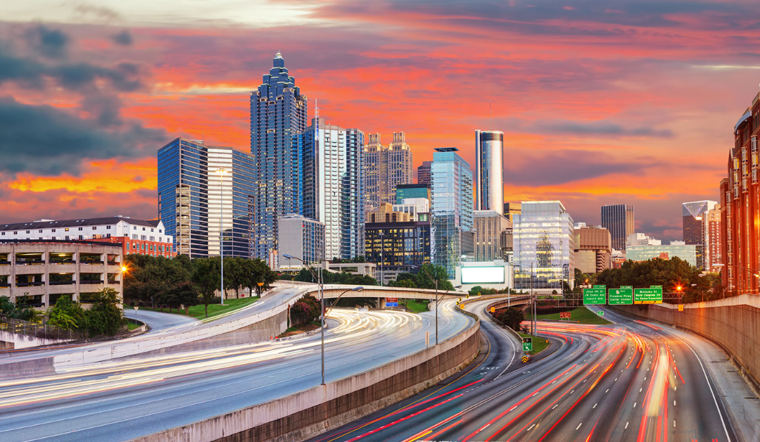 Photo of Atlanta cityscape against a sunset