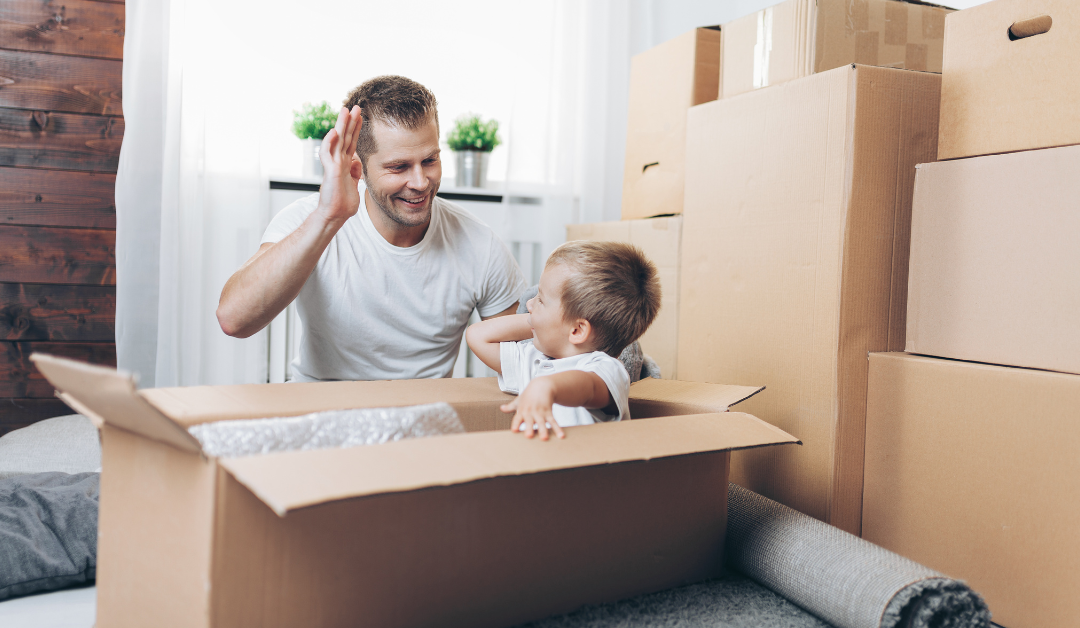 photo of someone high fiving their son inside of a moving box