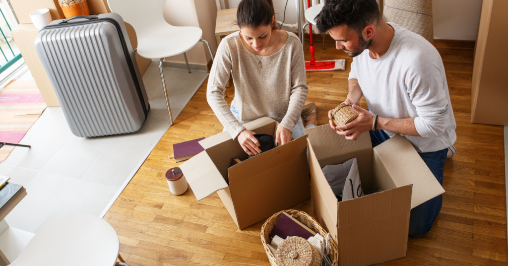 man and woman packing moving boxes on the floor