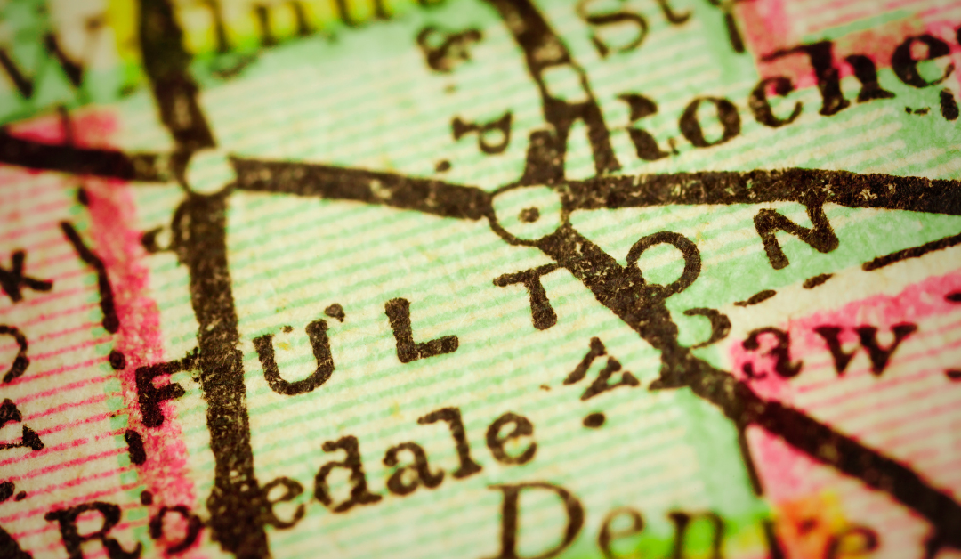 A close-up image of a vintage map showing the town of Fulton, surrounded by other towns and roads. The map is slightly aged and has a warm color palette.