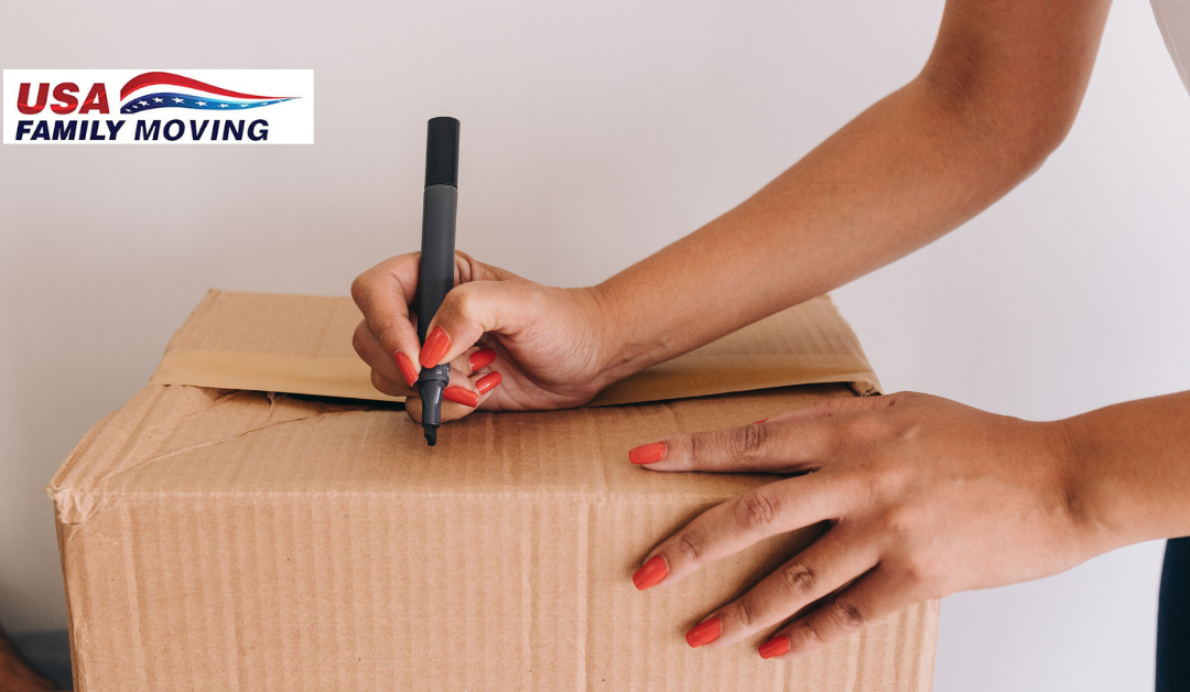 Woman labeling a moving box with a black marker