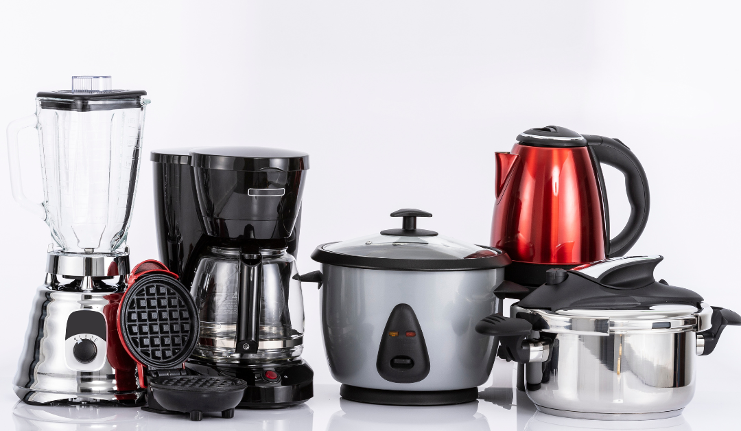 A set of stainless steel, black, and red kitchen appliances.